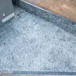 vertical concrete wall with patio