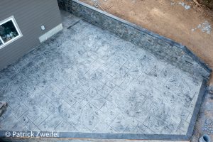 vertical concrete wall with patio