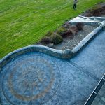 Custom Cut Ashlar Pattern & 13′ Medallion with Random Stone Concrete Retaining Wall