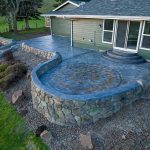 Custom Cut Ashlar Pattern & 13′ Medallion with Random Stone Concrete Retaining Wall