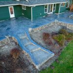 Custom Cut Ashlar Pattern & 13′ Medallion with Random Stone Concrete Retaining Wall