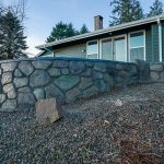Custom Cut Ashlar Pattern & 13′ Medallion with Random Stone Concrete Retaining Wall