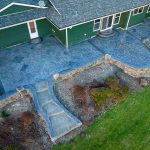 Custom Cut Ashlar Pattern & 13′ Medallion with Random Stone Concrete Retaining Wall