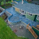 Custom Cut Ashlar Pattern & 13′ Medallion with Random Stone Concrete Retaining Wall