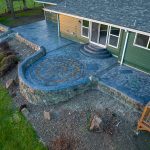 Custom Cut Ashlar Pattern & 13′ Medallion with Random Stone Concrete Retaining Wall