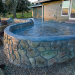 Custom Cut Ashlar Pattern & 13′ Medallion with Random Stone Concrete Retaining Wall