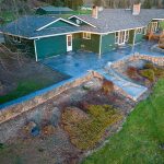 Custom Cut Ashlar Pattern & 13′ Medallion with Random Stone Concrete Retaining Wall