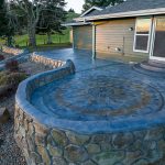 Custom Cut Ashlar Pattern & 13′ Medallion with Random Stone Concrete Retaining Wall