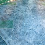 Custom Cut Ashlar Pattern & 13′ Medallion with Random Stone Concrete Retaining Wall