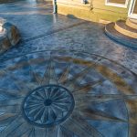 Custom Cut Ashlar Pattern & 13′ Medallion with Random Stone Concrete Retaining Wall
