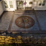 random stone concrete stamping with medallion and wood plank border