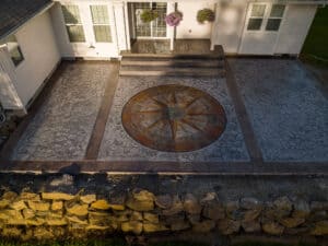 random stone concrete stamping with medallion and wood plank border