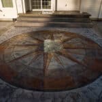 random stone concrete stamping with medallion and wood plank border