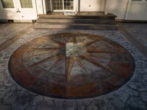 random stone concrete stamping with medallion and wood plank border