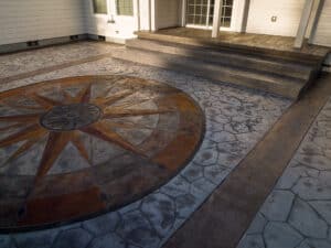 random stone concrete stamping with medallion and wood plank border