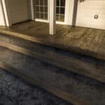random stone concrete stamping with medallion and wood plank border