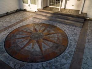 random stone concrete stamping with medallion and wood plank border