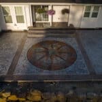 random stone concrete stamping with medallion and wood plank border