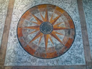random stone concrete stamping with medallion and wood plank border
