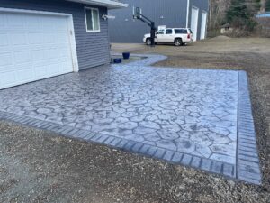 random stone brick border colored concrete driveway oregon