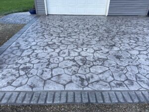 random stone brick border colored concrete driveway oregon