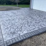 random stone brick border colored concrete driveway oregon