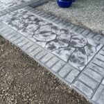 random stone brick border colored concrete driveway oregon