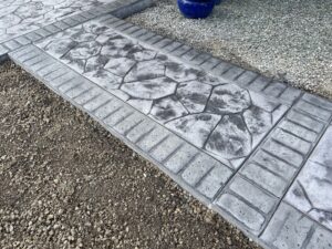 random stone brick border colored concrete driveway oregon