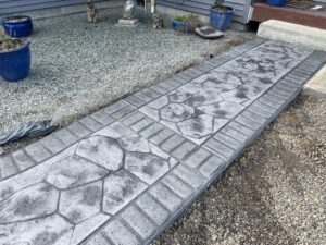 random stone brick border colored concrete driveway oregon