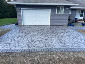 random stone brick border colored concrete driveway oregon